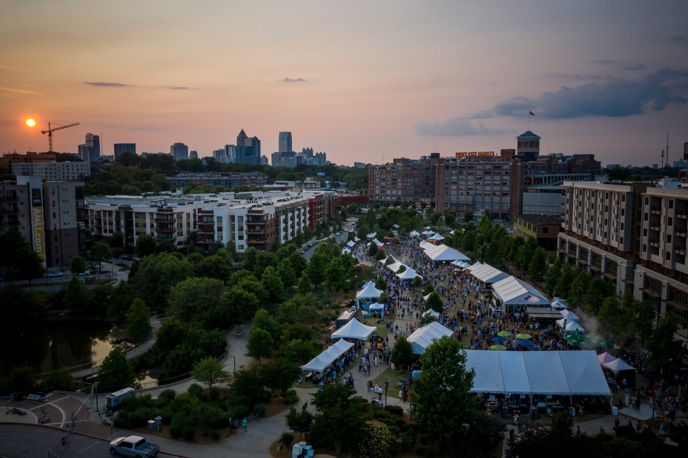 Atlanta Food & Wine Festival tasting tents at sunset with the Midtown skyline behind