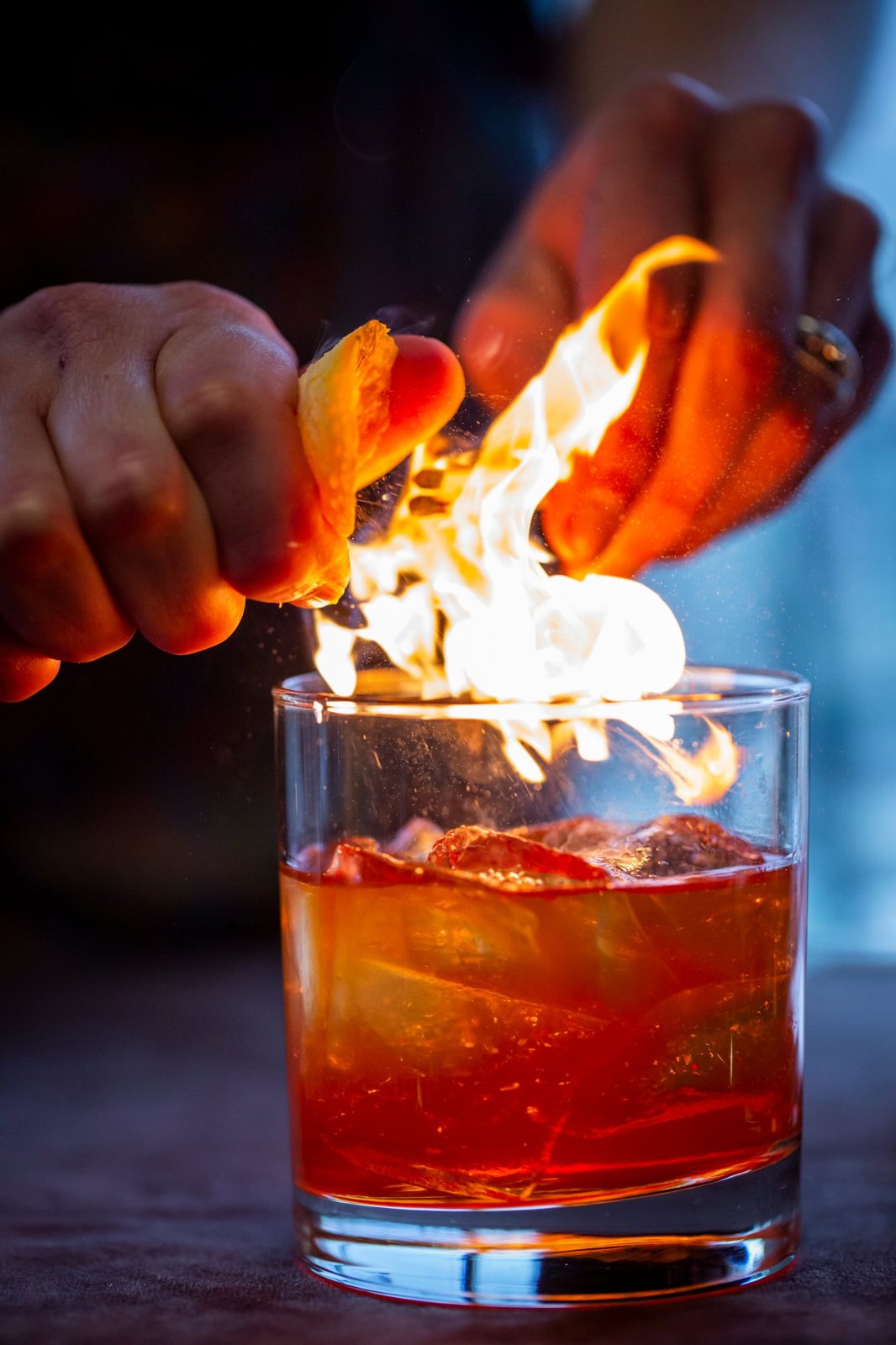 Flamed orange peel over a cocktail